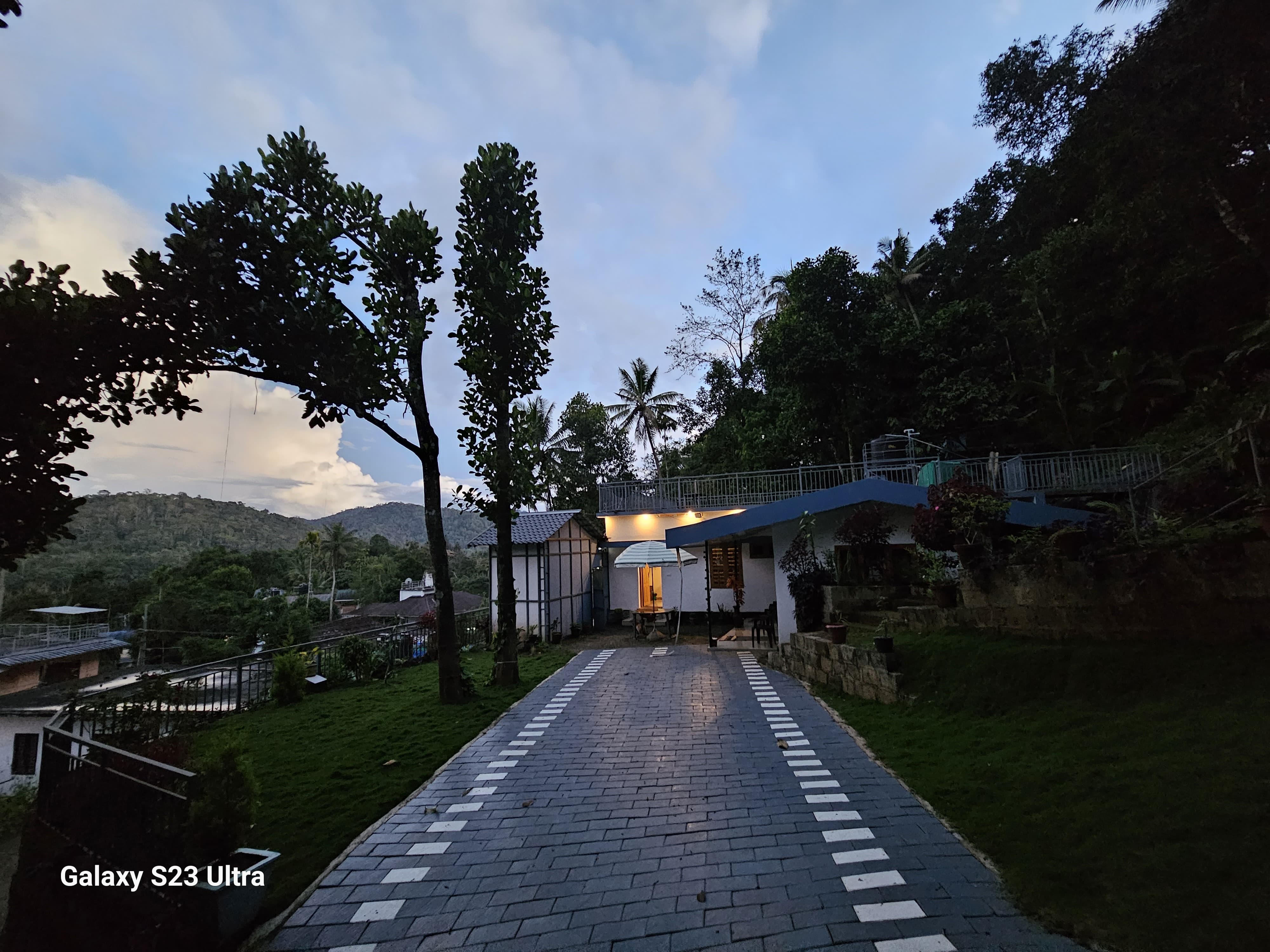 Bhaskar Home outdoor garden area with lush greenery and mountain views in Munnar